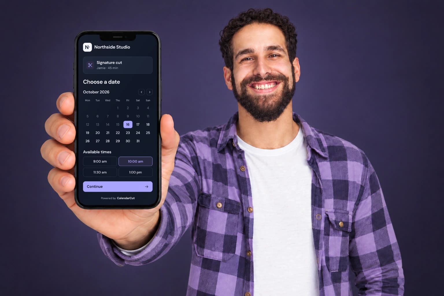 A client holding a Northside Studio branded booking page in dark mode