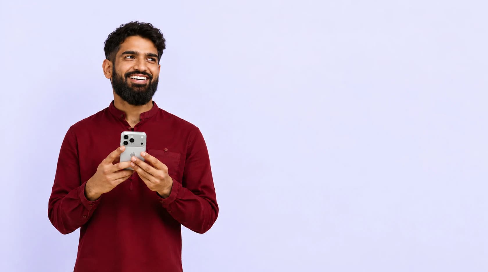 A client holding a phone to book a barber appointment